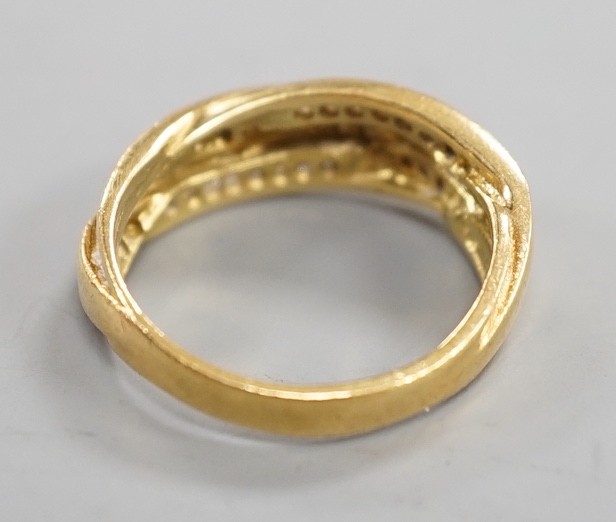 A modern 18ct gold and diamond chip set crossover ring, size N, gross weight 5.2 grams.